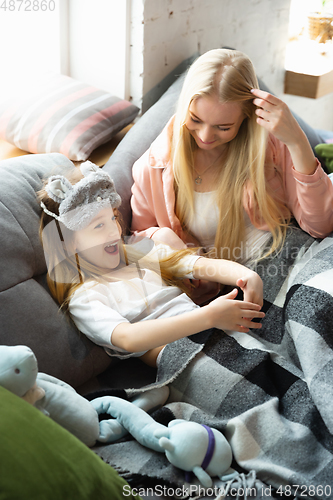 Image of Mother and daughter, sisters have quite, beauty and fun day together at home. Comfort and togetherness. Waking up in bedroom, good morning.