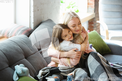 Image of Mother and daughter, sisters have quite, beauty and fun day together at home. Comfort and togetherness. Hugging, cozy and happy.