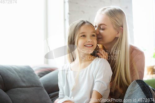 Image of Mother and daughter, sisters have quite, beauty and fun day together at home. Comfort and togetherness. Telling a secrets, joking.