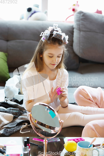 Image of Close up of mother and daughter, sisters have beauty and fun day together at home. Comfort and togetherness. Do a make up, hairstyle, manicure