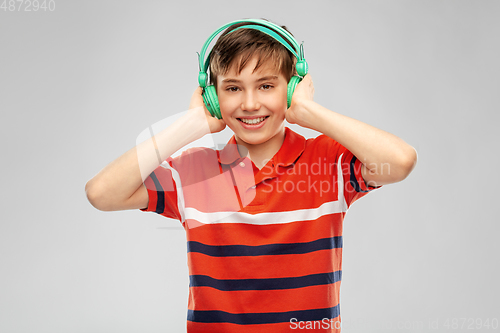 Image of smiling boy in headphones listening to music