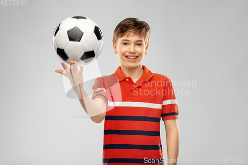 Image of happy smiling boy holding soccer ball