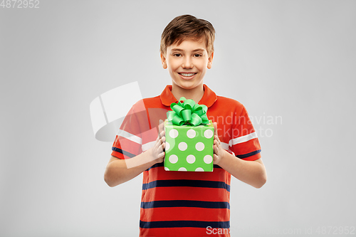 Image of portrait of happy smiling boy with gift box