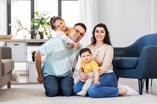 Image of portrait of happy family sitting on sofa at home