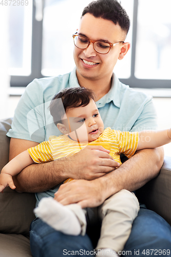 Image of happy father with little baby son at home