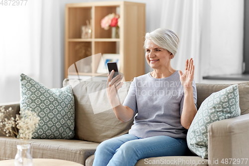 Image of senior woman having video call on smartphone