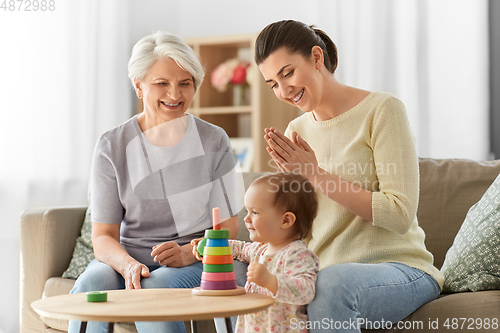 Image of mother, baby daughter and granny playing at home