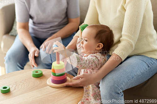 Image of mother, baby daughter and granny playing at home