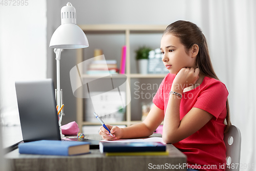 Image of student girl with laptop computer learning at home