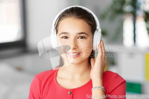 Image of girl in headphones listening to music at home
