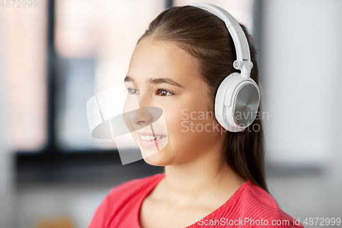 Image of girl in headphones listening to music at home