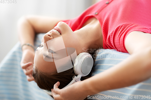 Image of girl in headphones listening to music at home