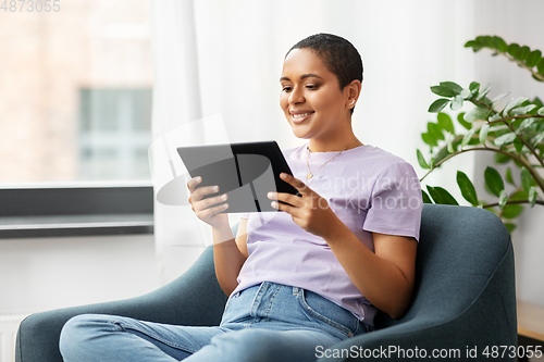 Image of african american woman with tablet pc at home