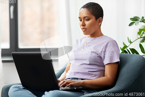 Image of african american woman with laptop at home