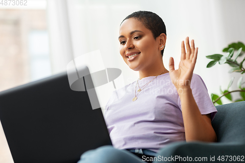 Image of african woman with laptop having video call
