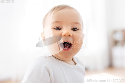 Image of portrait of happy laughing little baby at home