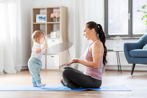 Image of happy mother with little baby at home