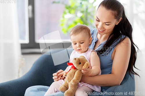 Image of happy mother with little baby daughter at home