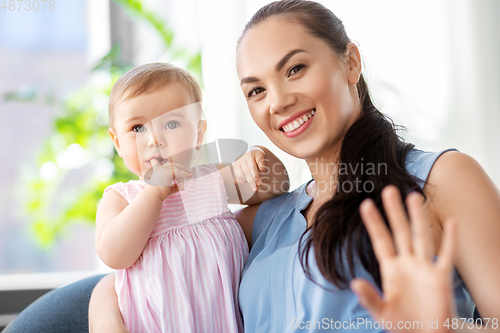 Image of happy mother with little baby daughter at home