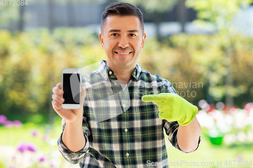 Image of middle-aged man with smartphone at summer garden