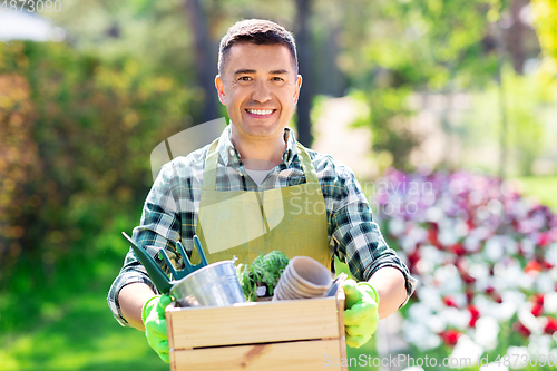 Image of happy man with tools in box at summer garden