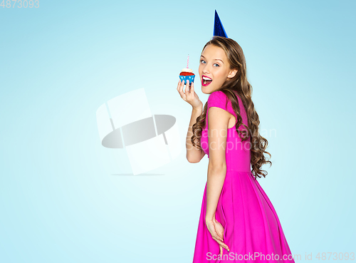 Image of happy woman or teen girl with birthday cupcake