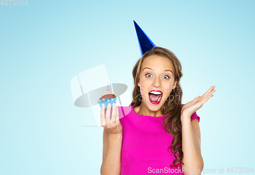 Image of happy woman or teen girl with birthday cupcake