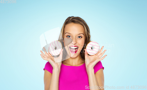 Image of happy woman or teen girl with donuts