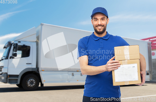 Image of happy delivery man with parcel boxes