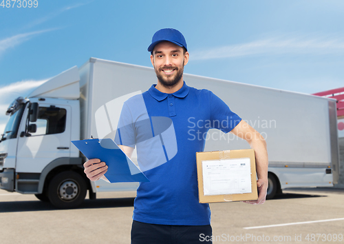 Image of happy delivery man with parcel box and clipboard