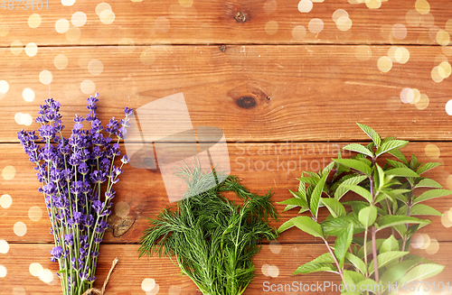 Image of lavender, dill and peppermint on wooden background