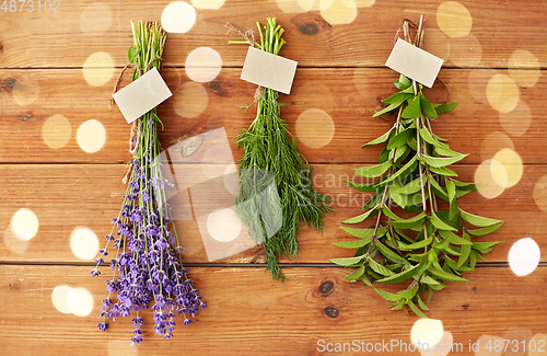 Image of lavender, dill and peppermint on wooden background