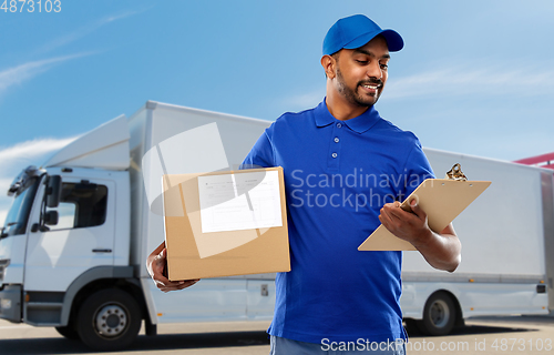 Image of indian delivery man with parcel box and clipboard