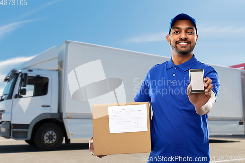 Image of indian delivery man with smartphone and parcel box