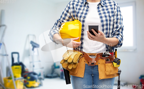 Image of woman or builder with phone and working tools