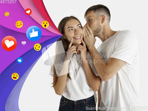 Image of Colorful drawing in cartoon style collaged with portrait of young caucasian couple with waves of likes, emotions, social network icons