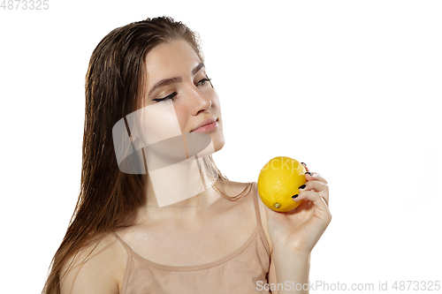 Image of Youth secrets. Beautiful young woman with lemon over white background. Cosmetics and makeup, natural and eco treatment, skin care.
