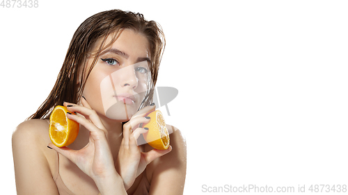 Image of Organic. Beautiful young woman with orange slices over white background. Cosmetics and makeup, natural and eco treatment, skin care. Flyer with copyspace.