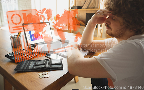 Image of Interface modern technology and digital layer effect. Man counting, working in despair, went bankrupt. Business, finance crisis, economics recession, unemployment concept.