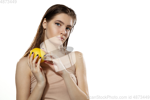 Image of Youth secrets. Beautiful young woman with lemon over white background. Cosmetics and makeup, natural and eco treatment, skin care.