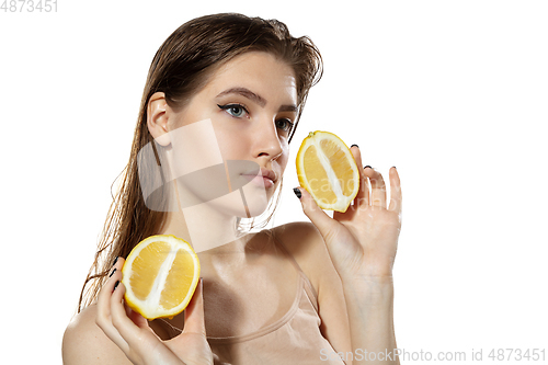 Image of Summer. Beautiful young woman with lemon slice over white background. Cosmetics and makeup, natural and eco treatment, skin care.