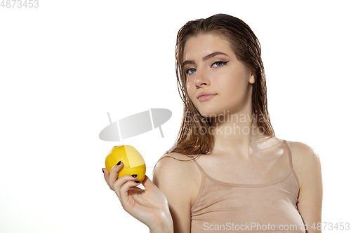 Image of Youth secrets. Beautiful young woman with lemon over white background. Cosmetics and makeup, natural and eco treatment, skin care.