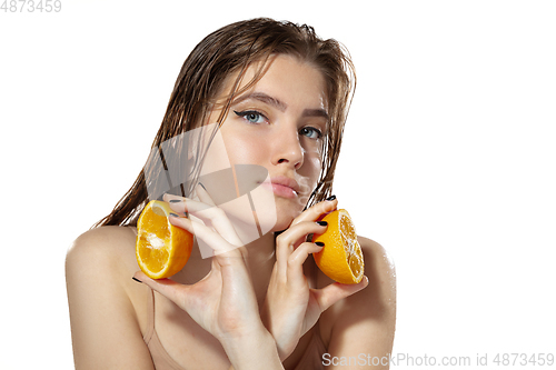 Image of Organic. Beautiful young woman with orange slices over white background. Cosmetics and makeup, natural and eco treatment, skin care.