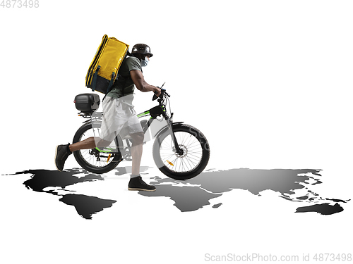 Image of Home delivery, food purchase via the Internet. Deliveryman on bike arriving to any address worldwide on the map with your order.