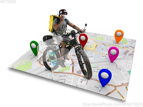 Image of Home delivery, food purchase via the Internet. Deliveryman on bike arriving to any address worldwide on the map with your order.