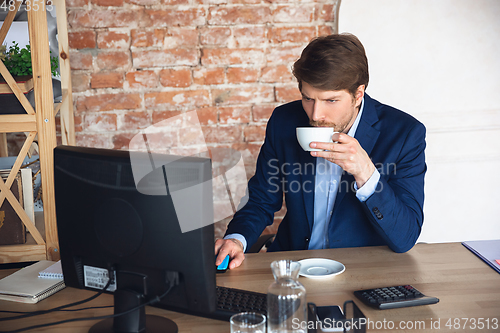 Image of Young man, manager, team led return to work in his office after quarantine, feels happy and inspired