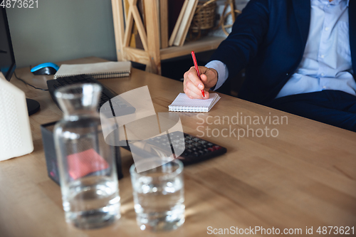 Image of Young man, manager, team led return to work in his office after quarantine, feels happy and inspired