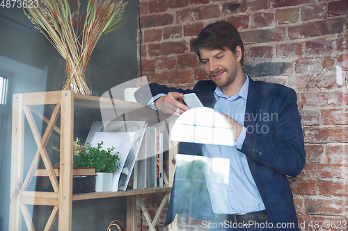 Image of Young man, manager, team led return to work in his office after quarantine, feels happy and inspired