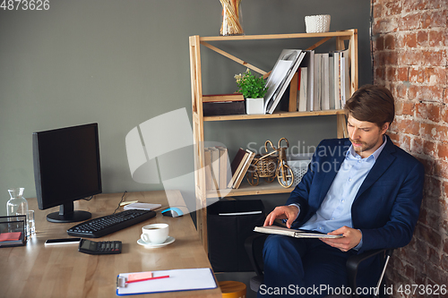 Image of Young man, manager, team led return to work in his office after quarantine, feels happy and inspired