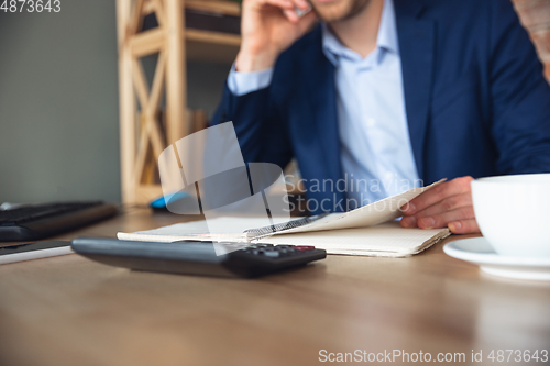 Image of Young man, manager, team led return to work in his office after quarantine, feels happy and inspired